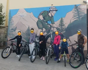 Cyclists gathered at Pikalty Rabat mural before a weekend bike tour