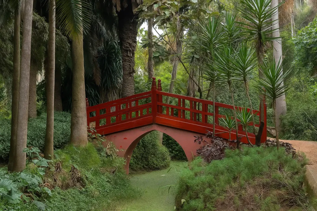 Red bridge in the lush Exotic Gardens of Bouknadel, one of the top things to do in Rabat