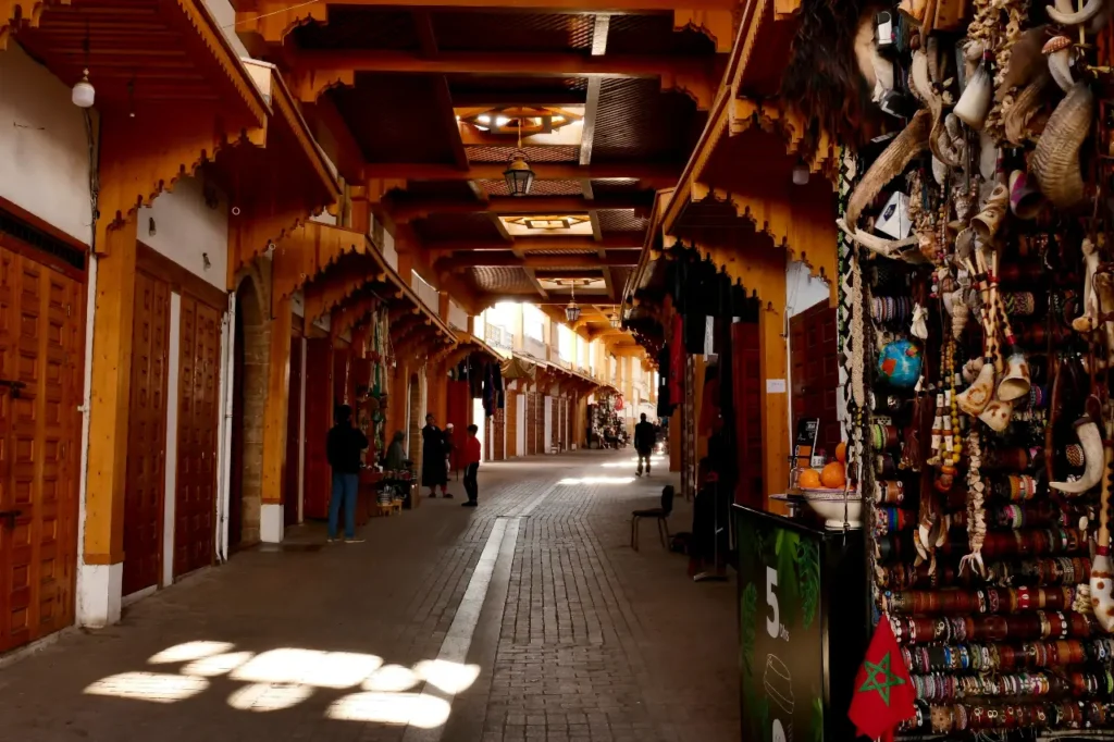 Covered souk alley in Rabat’s Medina with wooden arches, artisanal shops, and local crafts