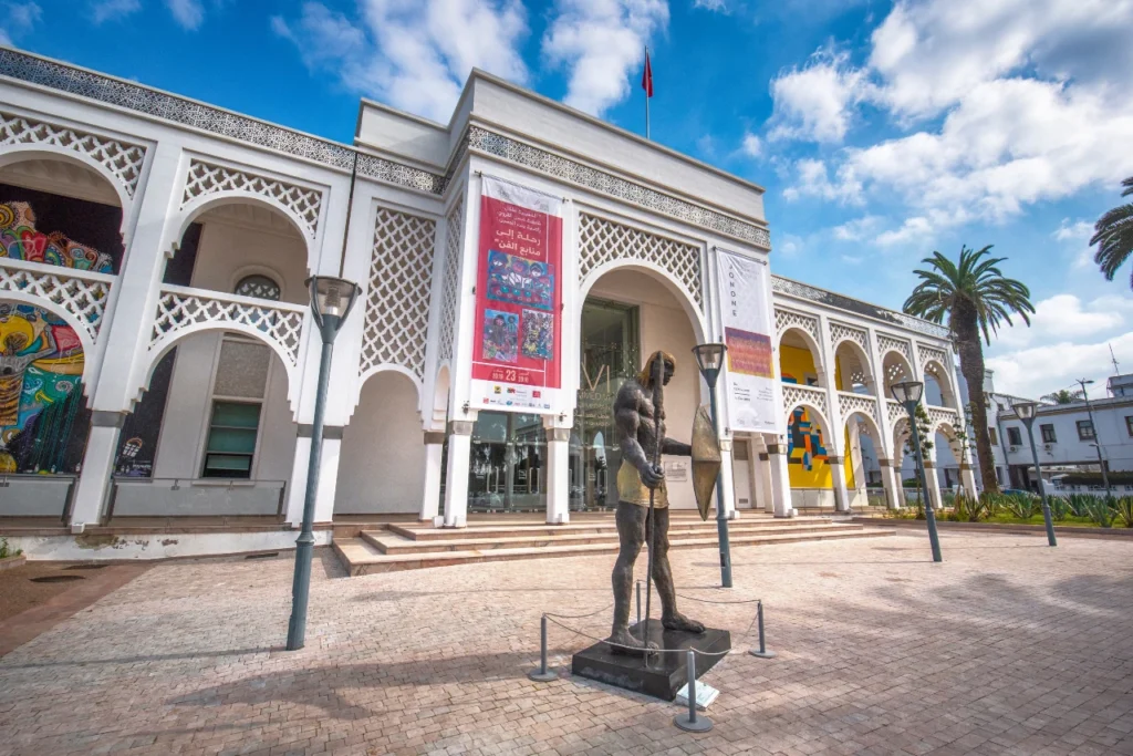 Entrance of the Mohammed VI Museum of Modern and Contemporary Art in Rabat, Morocco, with banners and outdoor sculpture