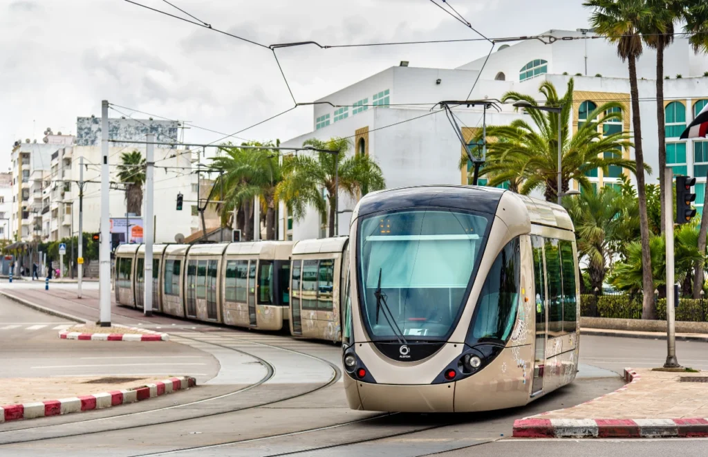 Modern tram in Rabat passing through the city with palm trees and buildings in the background