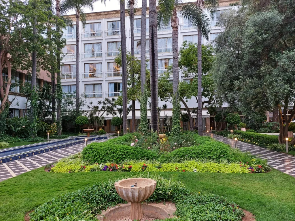 Garden view of Tour Hassan Palace Hotel in Rabat with palm trees and fountain