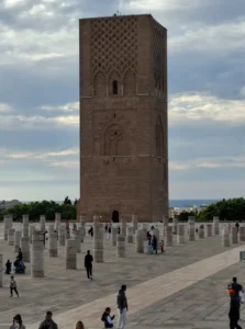 Featured image for goRabat blog post "How Many Days in Rabat" showing the historic Hassan Tower and its pillars under a dramatic sky.
