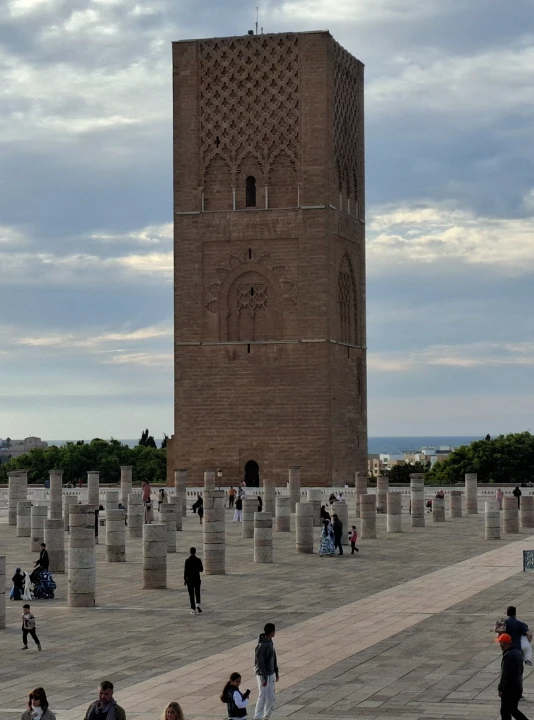 Featured image for goRabat blog post "How Many Days in Rabat" showing the historic Hassan Tower and its pillars under a dramatic sky.