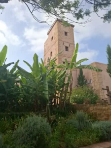 The Kasbah of the Oudayas tower seen through banana trees and garden greenery in Rabat