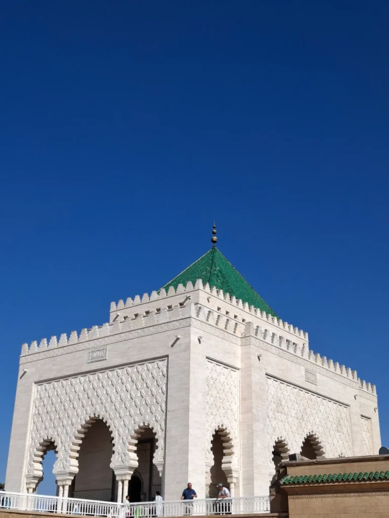 The stunning white marble Mausoleum of Mohammed V framed by ancient columns on the Hassan Tower esplanade, a key stop on a 2-day Rabat itinerary.